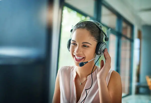 Customer service professional with headset smiling
